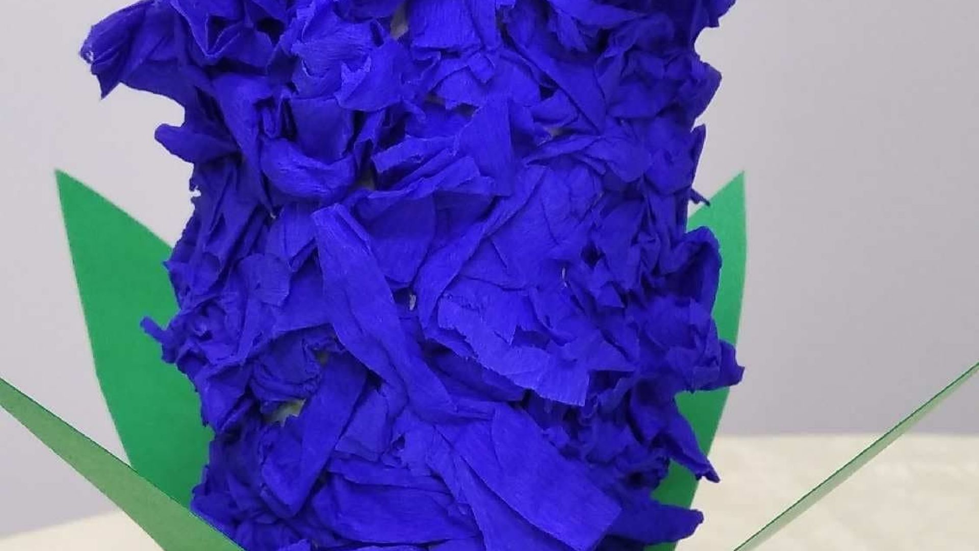 Hiacynt wykonany z rolki po papierze toaletowym, w dolnej części przyklejone zielone liście, w górnej części kwiaty z niebieskiej bibuły. Autor: Ewelina B.