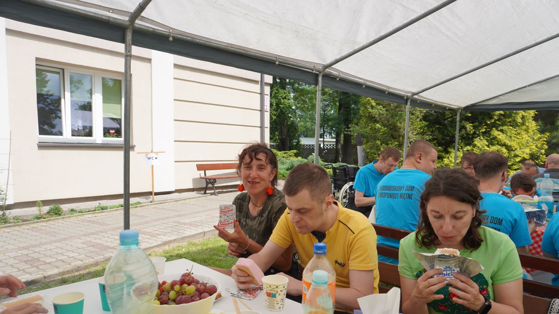 Uczestnicy naszego Domu jędzą lody podczas III Pikniku u Józefa w DPS św. Józefa w Mieni.
