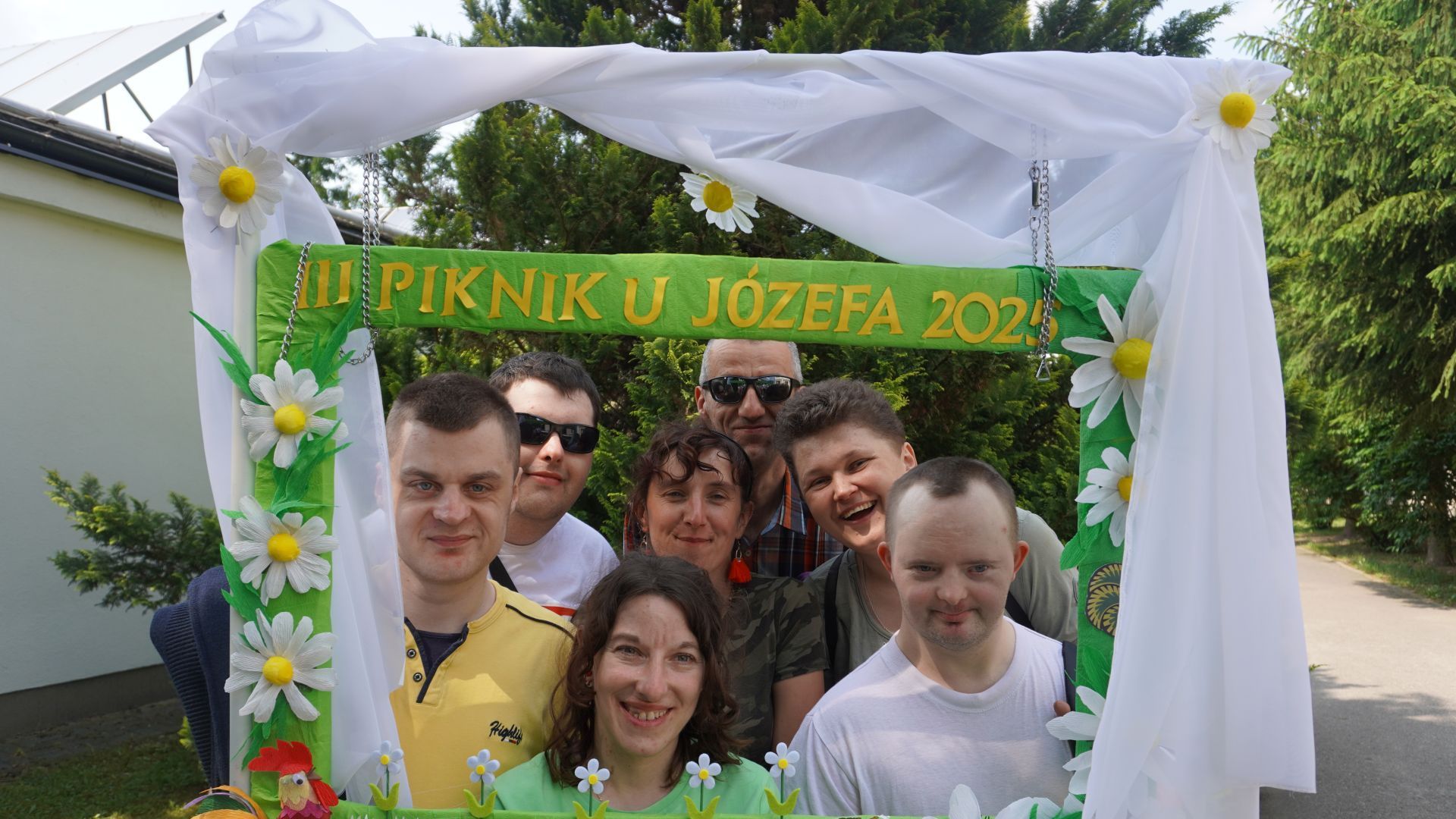 Uczestnicy pozują do wspólnego zdjęcia z ozdobną ramką z napisem III Piknik u Józefa 2025.